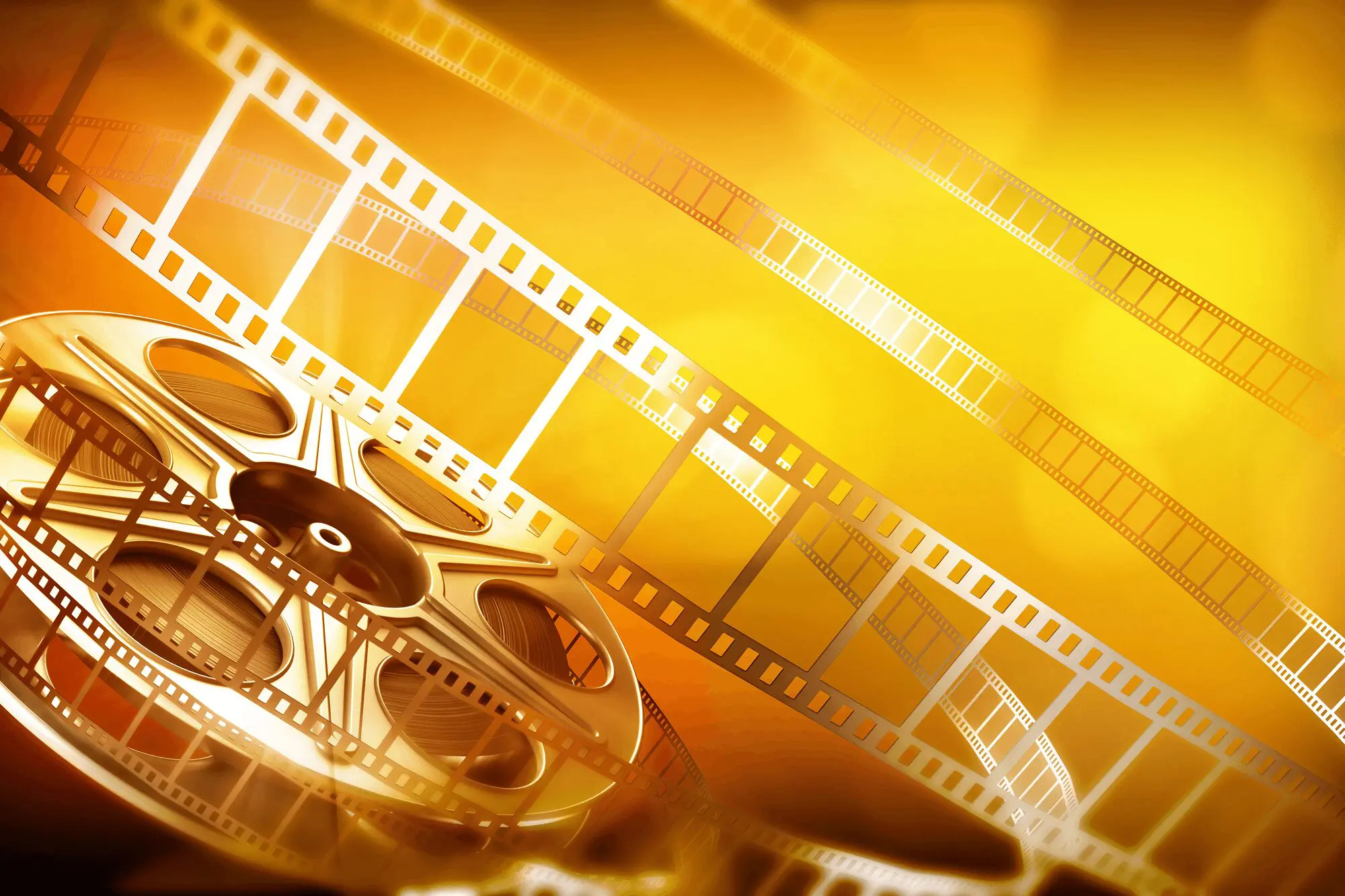 blog1 (1) A film reel with several strips of film unwinding against a bright, golden background.